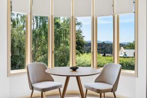 a table and two chairs in front of a window at Lizzy's Hideaway, Close to City in West Hobart