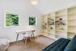a room with a desk and bookshelves at Lizzy's Hideaway, Close to City in West Hobart