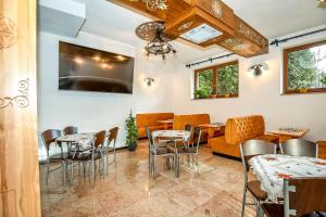 a restaurant with tables and chairs in a room at DW Maria 1 Zakopane in Zakopane