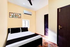 Postel nebo postele na pokoji v ubytování Hotel O Eswar RR Residency