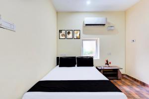 Postel nebo postele na pokoji v ubytování Hotel O Eswar RR Residency