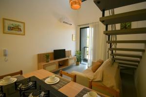 a living room with a spiral staircase and a living room at Loft Novo Campeche in Florianópolis