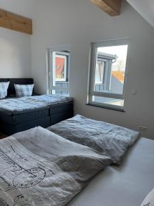 a bedroom with two beds and a mirror on the wall at Pension Romantica in Rust