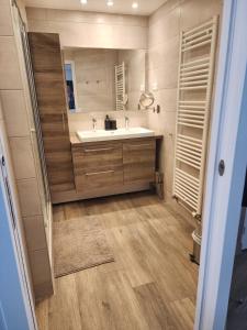 a bathroom with a sink and a mirror at FAMILY APARTMENT's LUXURY in Montrouge +55 photos