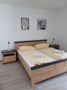 a bedroom with a large bed and two night stands at Apartment Mountain View with Private Sauna in Bad Hofgastein