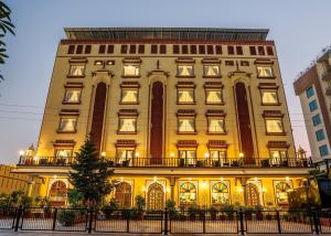 a tall yellow building with lights on it at Umaid Residency - A Regal Heritage Home in Jaipur
