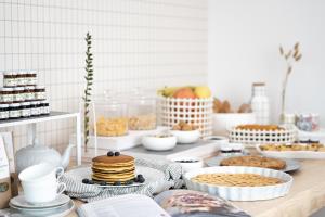 a table topped with plates and bowls of food at Hotel Trento Alta in Sardagna