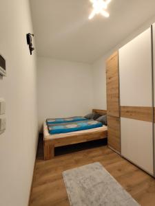 a small bedroom with a bed and a closet at Cozy Apartments in Central Location with Free Parking on Availability in Vienna +116 photos