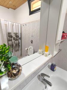a bathroom with a sink and a mirror at Appartamenti Poseidon in Marsala