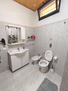 a bathroom with a toilet and a sink at Appartamenti Poseidon in Marsala