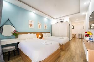 Кровать или кровати в номере Rum Resort Phu Quoc +64 фотографии