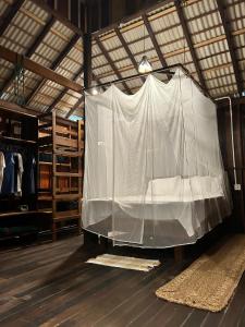 a room with a white curtain on the floor at Sunset Valley Bungalow in Camocim