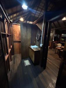 an inside view of a room with a wooden floor at Sunset Valley Bungalow in Camocim