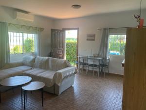 a living room with a couch and a table at Villa Vanessa in Alhaurín de la Torre