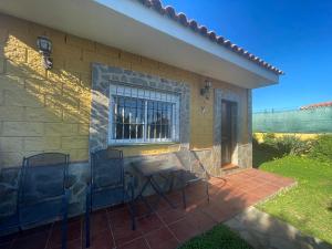 a patio with chairs and a table and a window at Villa Vanessa in Alhaurín de la Torre