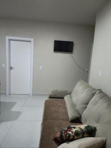 a living room with a couch and a flat screen tv at Casa do Vo Lelo in Penha