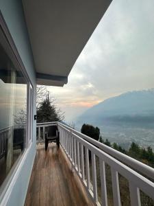 a balcony of a house with a view of the mountains at S Veer Homestay Sethan in Jagatsukh