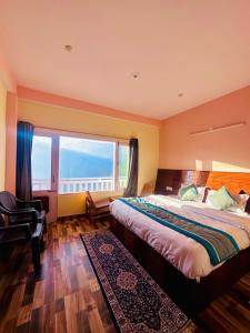 a bedroom with a large bed and a large window at S Veer Homestay Sethan in Jagatsukh +29 photos