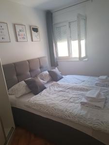 a bedroom with a large bed with two pillows at Margareta's Apartment in Kaštela