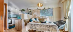 a kitchen with a table with a table cloth on it at Ferienhaus zur Maultrommel in Molln