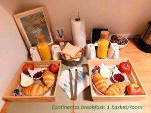 a table with two trays of food and bottles of orange juice at Comfy Stay 9052 in Ghent