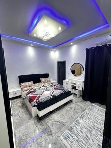 a bedroom with a bed and a blue ceiling at Wisdom in Rufisque