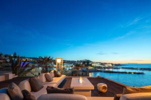 a living room with a view of the water at Zillion Villa - Sapphire Shores Beachfront Retreat by etouri in Panormos Rethymno +76 photos