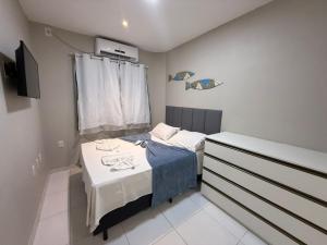 a small bedroom with a small bed and a dresser at Maria Farinha Residence Prince - LocarHouse in Maria Farinha +206 photos