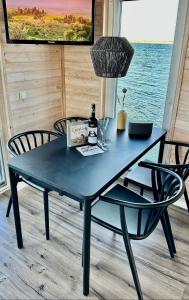 een blauwe tafel met 2 stoelen en een fles wijn bij Hausboot Koje INE Huus & Meer in Ortmühle