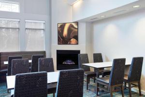 a conference room with a table and chairs and a fireplace at Residence Inn Detroit / Auburn Hills in Pontiac +18 photos