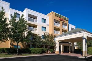 an exterior view of a hotel with a parking lot at Courtyard by Marriott Charlotte Gastonia in Gastonia
