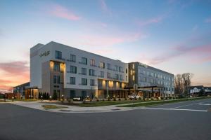 a large white building with a street in front of it at Courtyard Charlotte Steele Creek in Charlotte