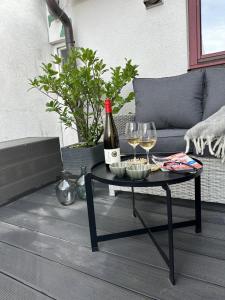 a table with a bottle of wine and wine glasses at Downtown No 3 in Bad Soden-Salmünster +27 photos