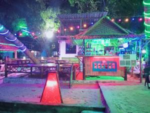 a playground with a bar in a park at night at Two Rocks Bungalows in Ban Tai