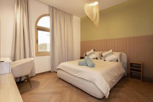 a bedroom with a bed and a table and a window at Luxurious Villa 5BHK with Pool BBQ and Full Time Housemaid Assistance - live in in Dubai