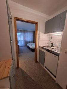 a kitchen with a door open to a living room at Chiemgau Appartement Lärche 3 Chiemgau Karte inklusive in Inzell