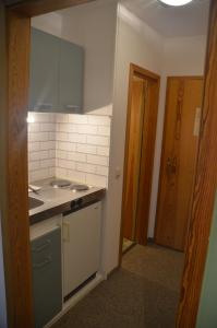 a kitchen with a sink and a counter top at Chiemgau Appartement Lärche 3 Chiemgau Karte inklusive in Inzell +6 photos