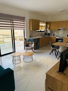 a kitchen with tables and chairs in a room at Brand new, Finikoudes area in Larnaka