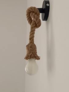 a rope hanging on a wall with a hook at Casa delle begonie in Rome +10 photos
