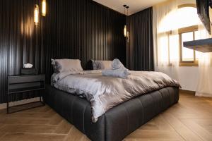 a bedroom with a bed with a stuffed animal on it at Luxurious Villa 5BHK with Pool BBQ and Full Time Housemaid Assistance - live in in Dubai