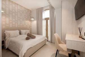 a white bedroom with a bed and a chair at Luxurious Villa 5BHK with Pool BBQ and Full Time Housemaid Assistance - live in in Dubai +67 photos