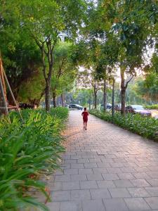 a small child walking down a brick sidewalk at Đã đóng cửa in Cong Luận +4 photos