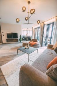 a living room with a couch and a table at LIVALPIN 2Enjoy - with private Sauna in Garmisch-Partenkirchen