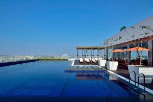 a swimming pool on the roof of a building at Marriott Executive Apartments Hyderabad in Hyderabad