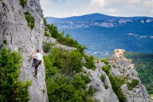 a man standing on a rock formation in the mountains at Apartmani Xenia & Desiderio in Buzet