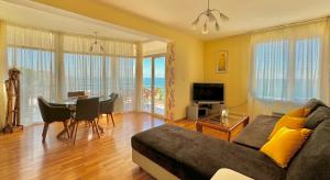 a living room with a couch and a table at Beachfront Havana in Sveti Vlas