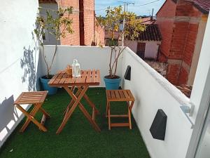 a table and two chairs on a balcony at Calderona Tiny house in Segorbe