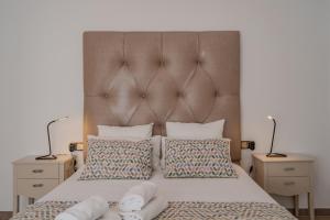 a bedroom with a large bed with two night stands at LIVING CAZORLA II in Cazorla