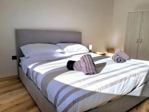 a bedroom with a large bed with towels on it at Isola Holiday in Feltre