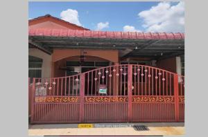 a red gate in front of a house at Mahsuri Homestay in Jitra